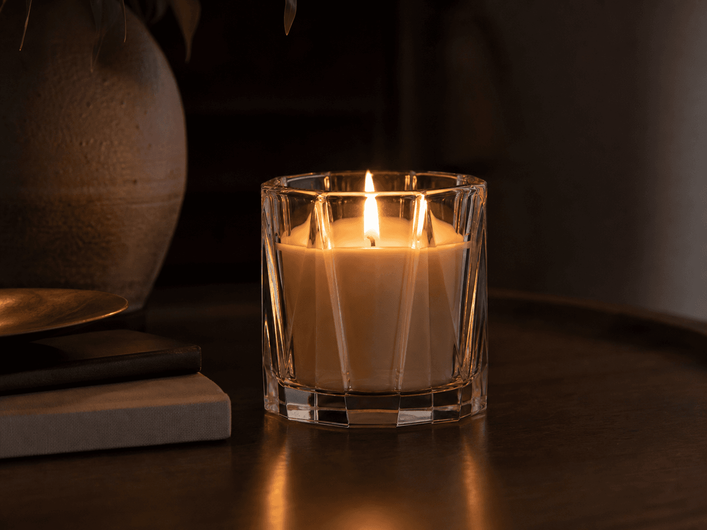 Geometric Faceted Candle Jar used for faceted vessels lit in a dark room in a evening ambience setting