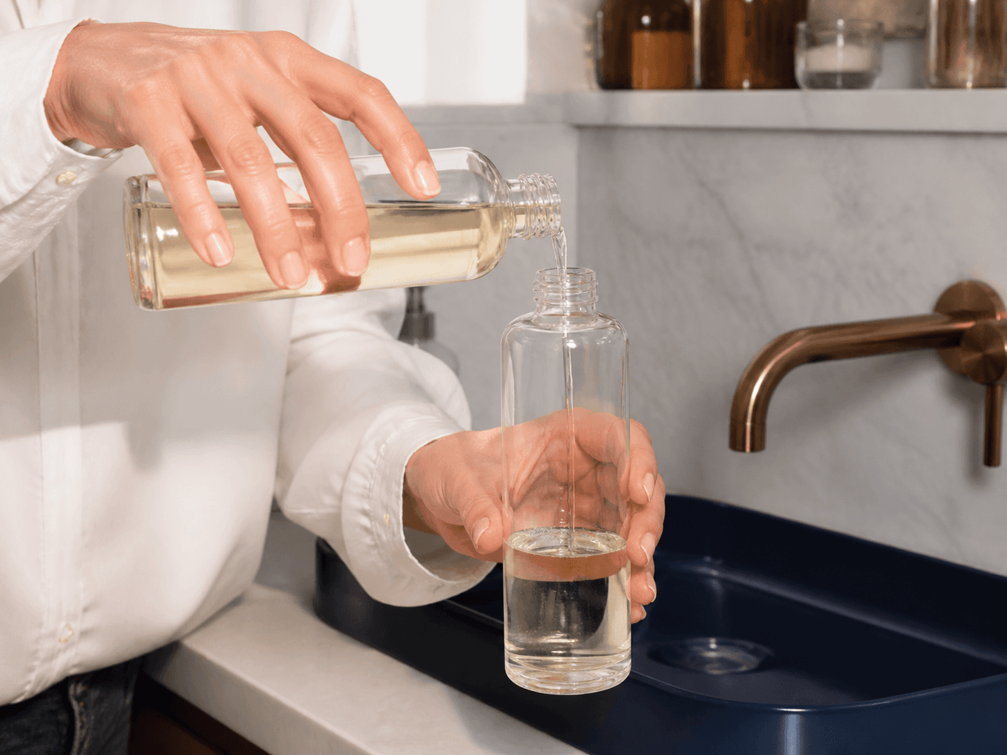 Refill Bottle used for decanting into a keepsake bottle in a fragrance refill setting