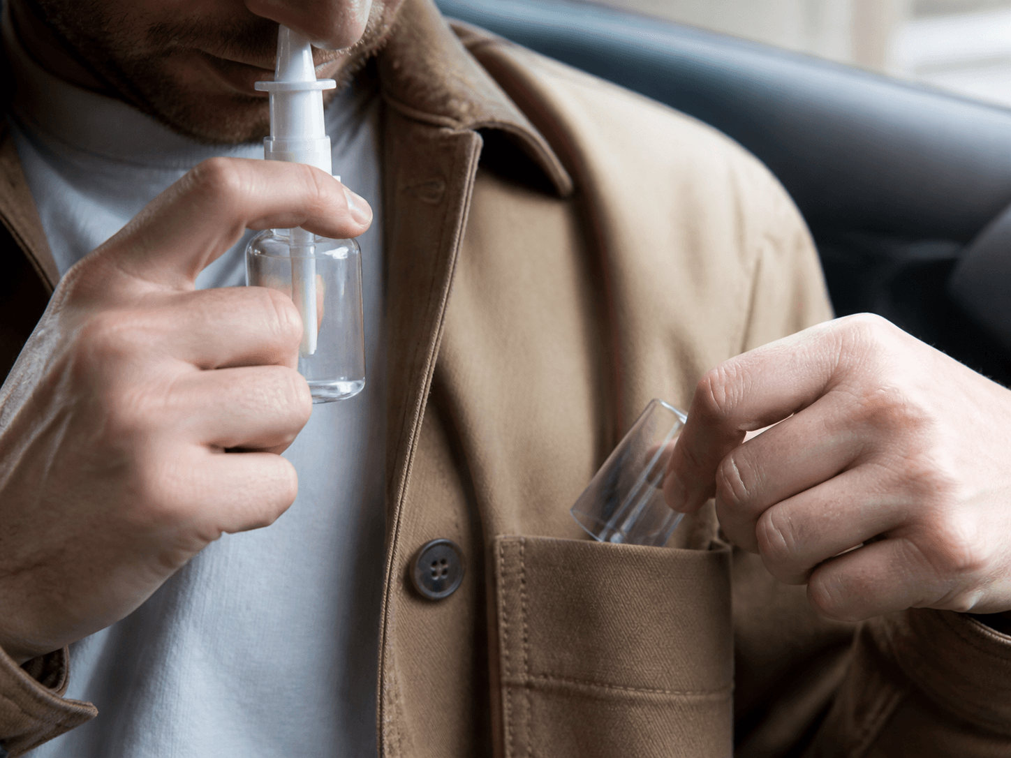Nasal Spray Bottle used for a tip that goes back into a coat in a carried in a pocket setting