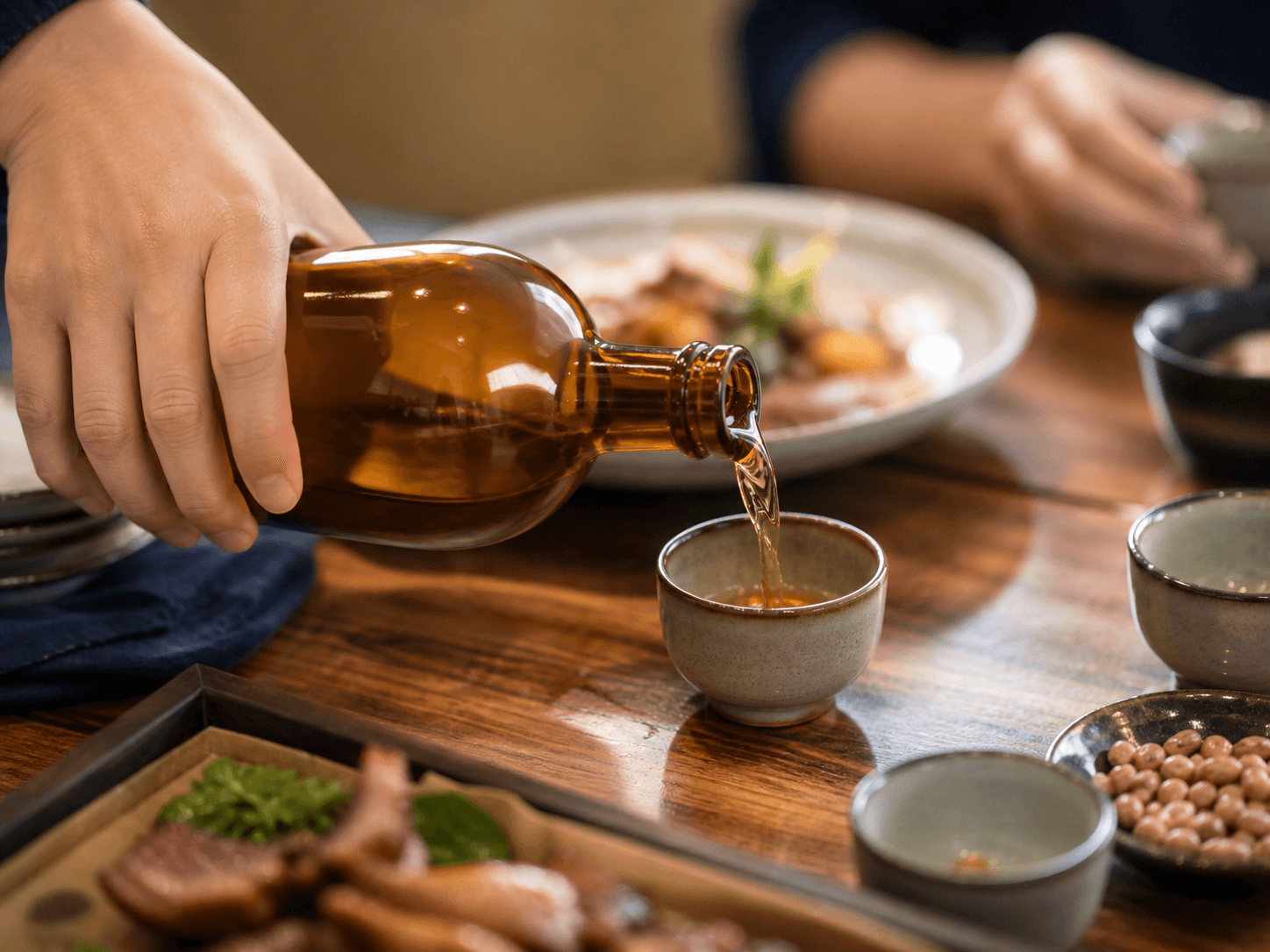 Yellow Rice Wine Bottle used for shared bottles poured into small cups in a table service setting