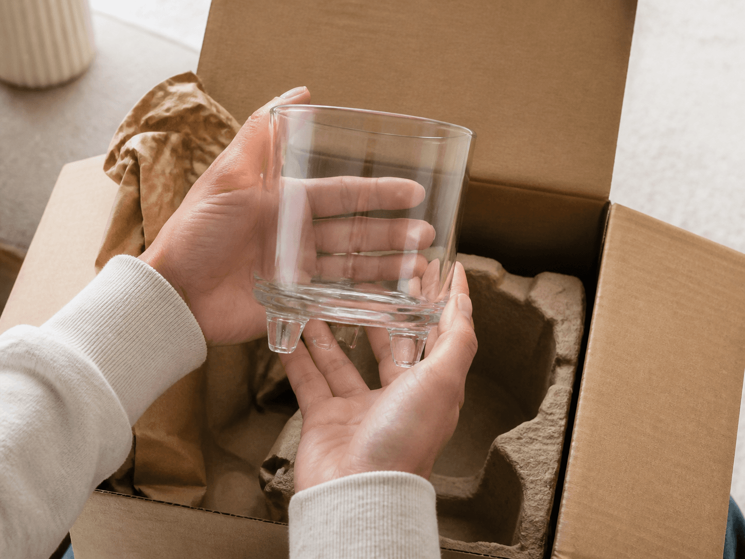Three-legged Candle Jar used for a candle unwrapped by the person who ordered it in a parcels to the door setting