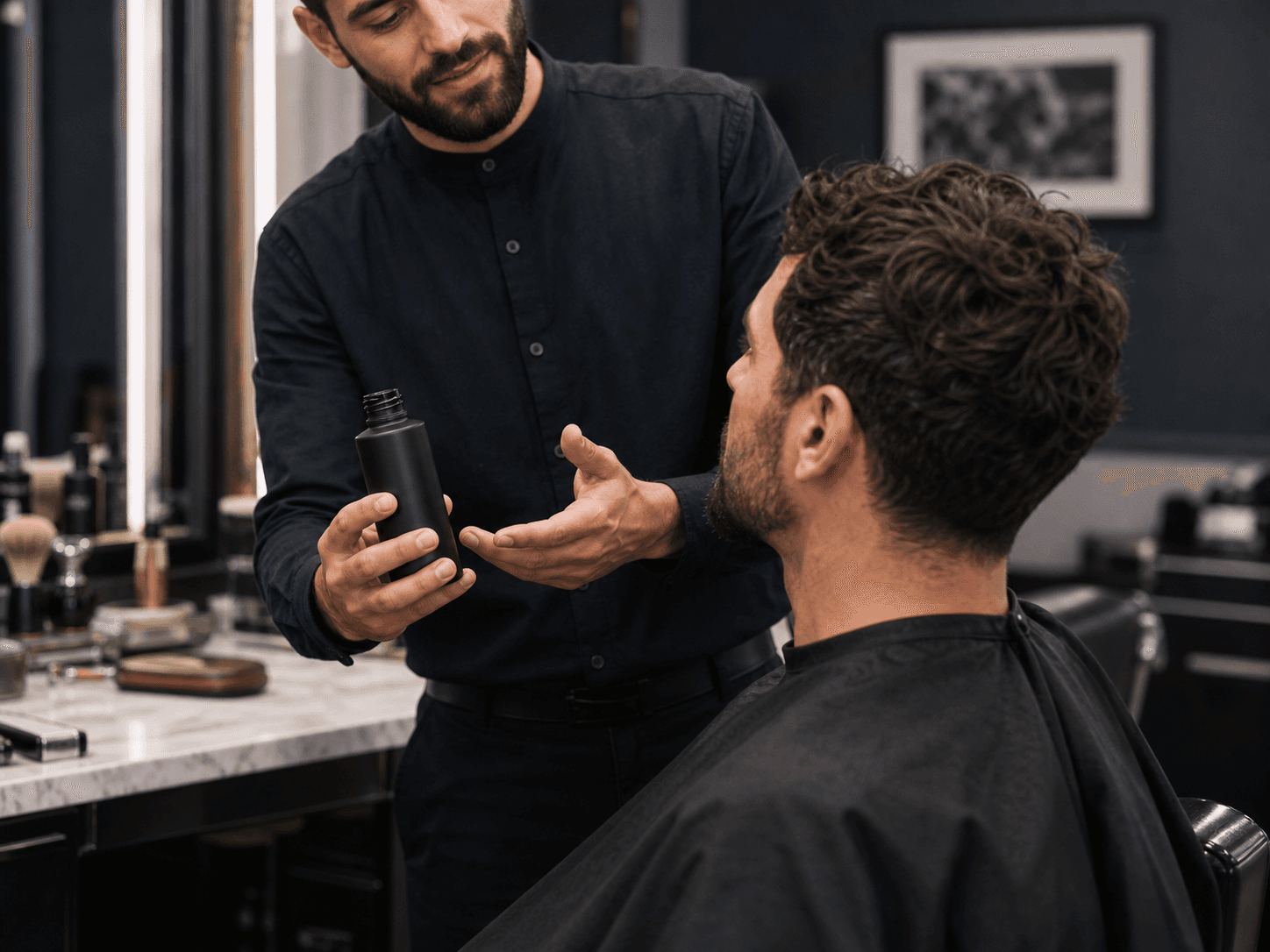 Men's Dark Frosted Bottle used for treatments recommended across a chair in a barber shops setting