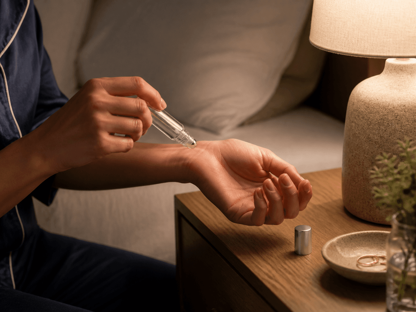 Roller Ball Bottle used for a blend rolled onto wrists at night in a bedside tables setting